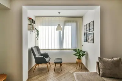 a living room with a chair and a window at Central flat Wi-Fi & streaming in Varna City