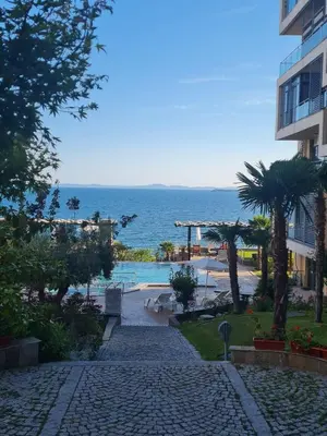 a walkway leading to a beach and a building at Dolce Vita 2, Appartement in Sveti Vlas