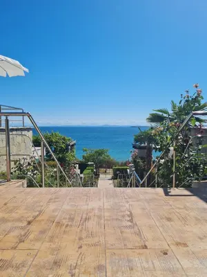 a wooden deck with the ocean in the background at Dolce Vita 2, Appartement in Sveti Vlas