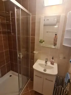 a bathroom with a shower and a sink and a mirror at Dolce Vita 2, Appartement in Sveti Vlas
