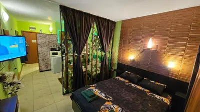 a bedroom with a bed and a television in it at Studio 39 in Sunny Beach