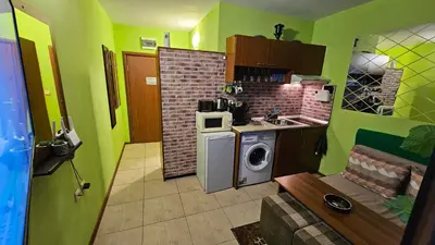 a small kitchen with a washing machine and a microwave at Studio 39 in Sunny Beach