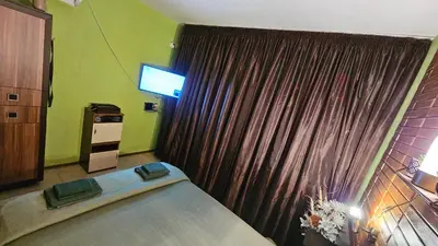 a bedroom with a bed and a television in a room at Studio 39 in Sunny Beach