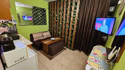 a small living room with a couch and a tv at Studio 39 in Sunny Beach