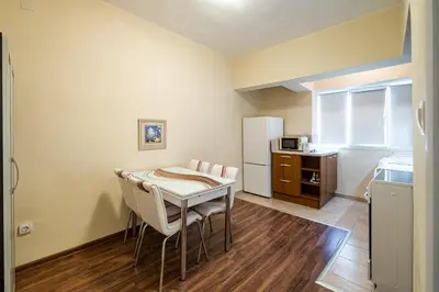 a kitchen with a table and chairs in a room at Primorski 2bdrm Central Apartment in Varna City