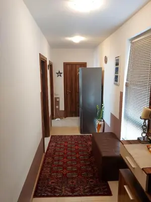 a living room with a refrigerator and a rug at Прекраснные апартаменты с панорамным видом на море in Byala
