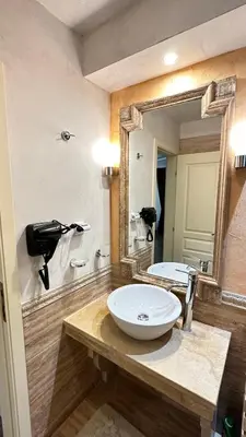 a bathroom with a sink and a large mirror at Penthouse Happy Moments 3 in Sunny Beach