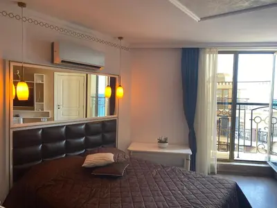 a bedroom with a large bed and a balcony at Penthouse Happy Moments 3 in Sunny Beach