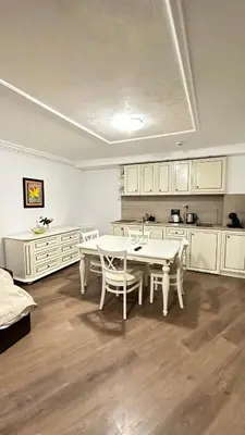 a kitchen with a table and chairs in a room at Penthouse Happy Moments 3 in Sunny Beach