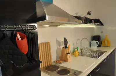 a kitchen with a sink and a counter top at Arlequin Apartment in Varna City