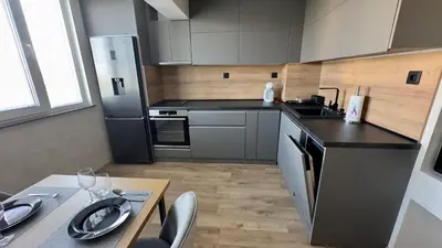 a kitchen with stainless steel appliances and a table at Apartment 122 in Burgas City