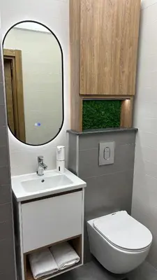a bathroom with a sink and a toilet and a mirror at Apartment 122 in Burgas City