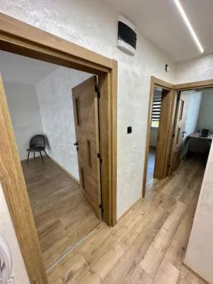 a hallway with a door and a room with a table at Apartment 122 in Burgas City