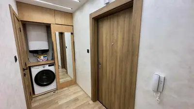 a laundry room with a washer and dryer and a door at Apartment 122 in Burgas City