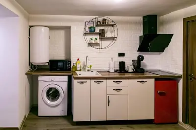 a kitchen with a washing machine and a washer at ToP center of Varna in Varna City