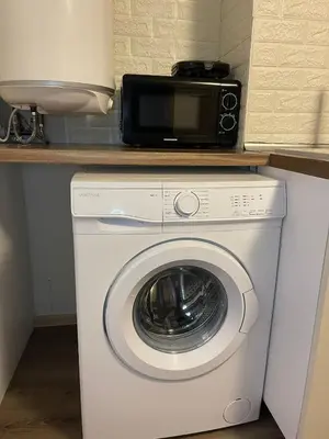 a microwave sitting on top of a washing machine at ToP center of Varna in Varna City