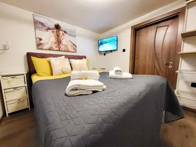a bedroom with a large bed with towels on it at ToP center of Varna in Varna City