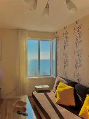 a bedroom with a bed and a large window at Beachfront Havana in Sveti Vlas