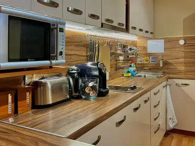 a kitchen with a counter top with a microwave at Beachfront Havana in Sveti Vlas