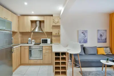 a small kitchen and living room with a couch at Central Paradise - free parking in Varna City