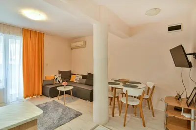 a living room with a couch and a table at Central Paradise - free parking in Varna City