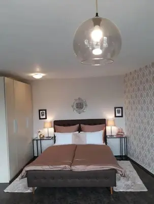 a bedroom with a large bed with two lamps at Central Apartment 5min to beach in Varna City