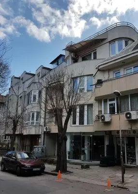 a car parked in front of a large building at Central Apartment 5min to beach in Varna City