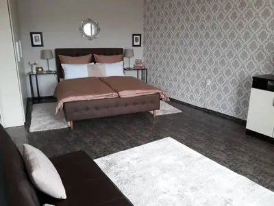 a bedroom with a bed and a couch at Central Apartment 5min to beach in Varna City