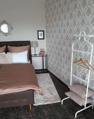 a bedroom with a bed and a chair in it at Central Apartment 5min to beach in Varna City