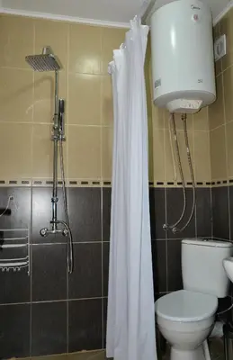 a bathroom with a toilet and a shower at DDenko Apartment in Burgas City