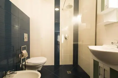 a bathroom with a toilet and a sink at Holiday Village Lozenets in Lozenets