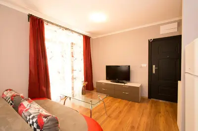 a living room with a couch and a television at Holiday Village Lozenets in Lozenets