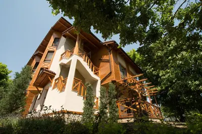 a house with wooden balconies on the side of it at Holiday Village Lozenets in Lozenets