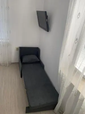 a room with a couch in the corner of a room at Bluemoon-Apartment with Parking in Burgas City