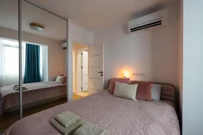 a bedroom with a large mirror and a bed at OPAL Beachfront Apartment in Varna City