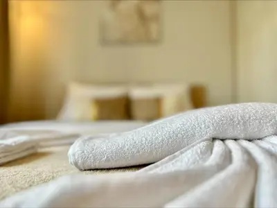 a pile of towels sitting on top of a bed at Panorama Dreams - Menada Apartments in Sveti Vlas