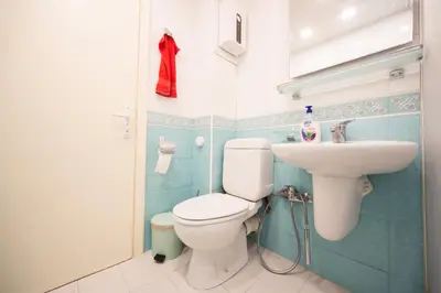 a bathroom with a toilet and a sink at Demokratsia bl 117 in Burgas City