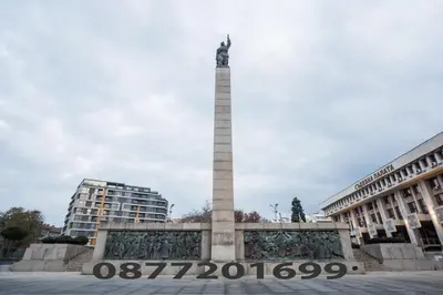 a monument in a square in front of two buildings at Demokratsia bl 117 in Burgas City