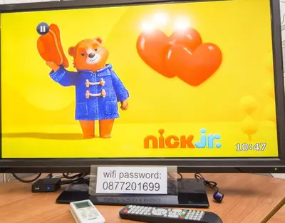 a computer monitor with a toy of a bear with balloons at The Square - Old Flat with 2 bedrooms, 1st fl in Burgas City