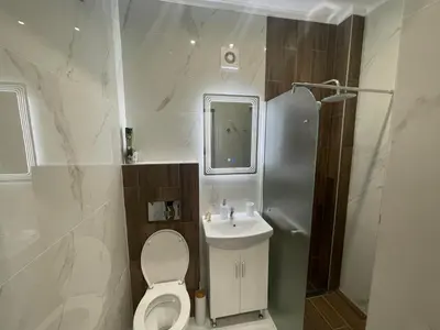 a bathroom with a toilet and a sink at City Center Apartment 2 in Varna City