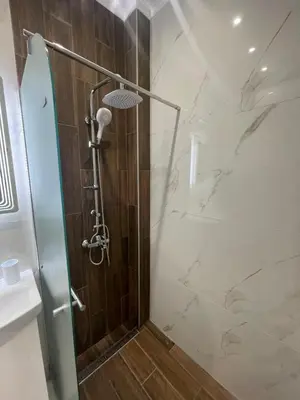 a bathroom with a shower with a glass door at City Center Apartment 2 in Varna City