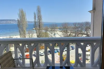 a balcony with a view of a beach and the ocean at Beachfront Panoramic Flat @ South Bay residence in Varna City