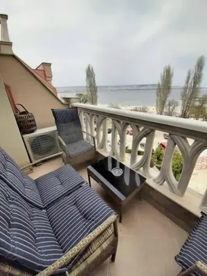 a balcony with chairs and a view of the beach at Beachfront Panoramic Flat @ South Bay residence in Varna City