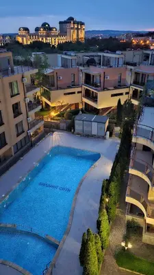 an aerial view of a building with a swimming pool at Таунхаус с шикарной террасой in Sveti Vlas