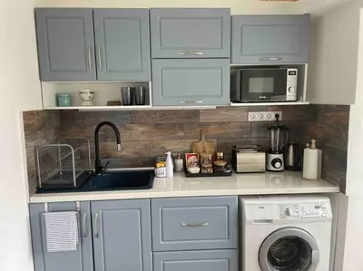 a kitchen with a sink and a microwave at Sunny Seaside Retreat in Burgas in Burgas City
