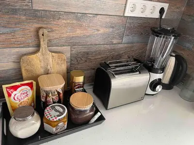 a kitchen counter with a toaster oven and other ingredients at Sunny Seaside Retreat in Burgas in Burgas City