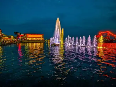 a fountain in the middle of the water at night at Къща Каменар in Pomorie