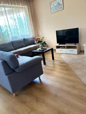 a living room with a couch and a flat screen tv at Къща Каменар in Pomorie