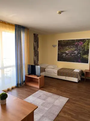 a bedroom with a bed and a tv in it at Hotel Star in Sunny Beach