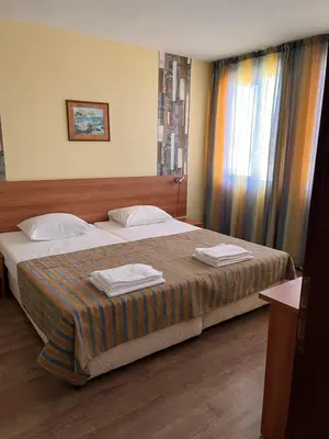 a hotel room with two beds and a window at Hotel Star in Sunny Beach